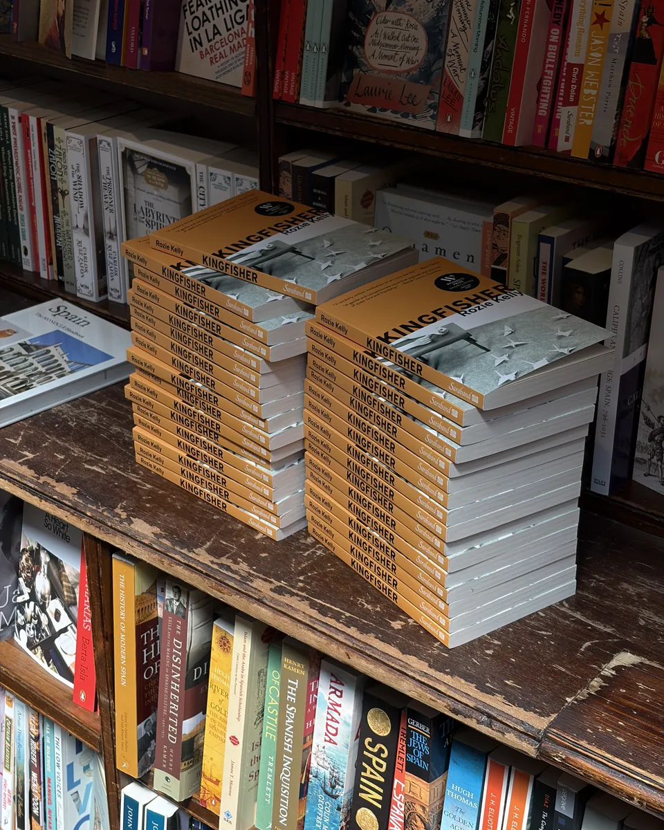 Two tall stacks of Kingfisher on a bookshop table