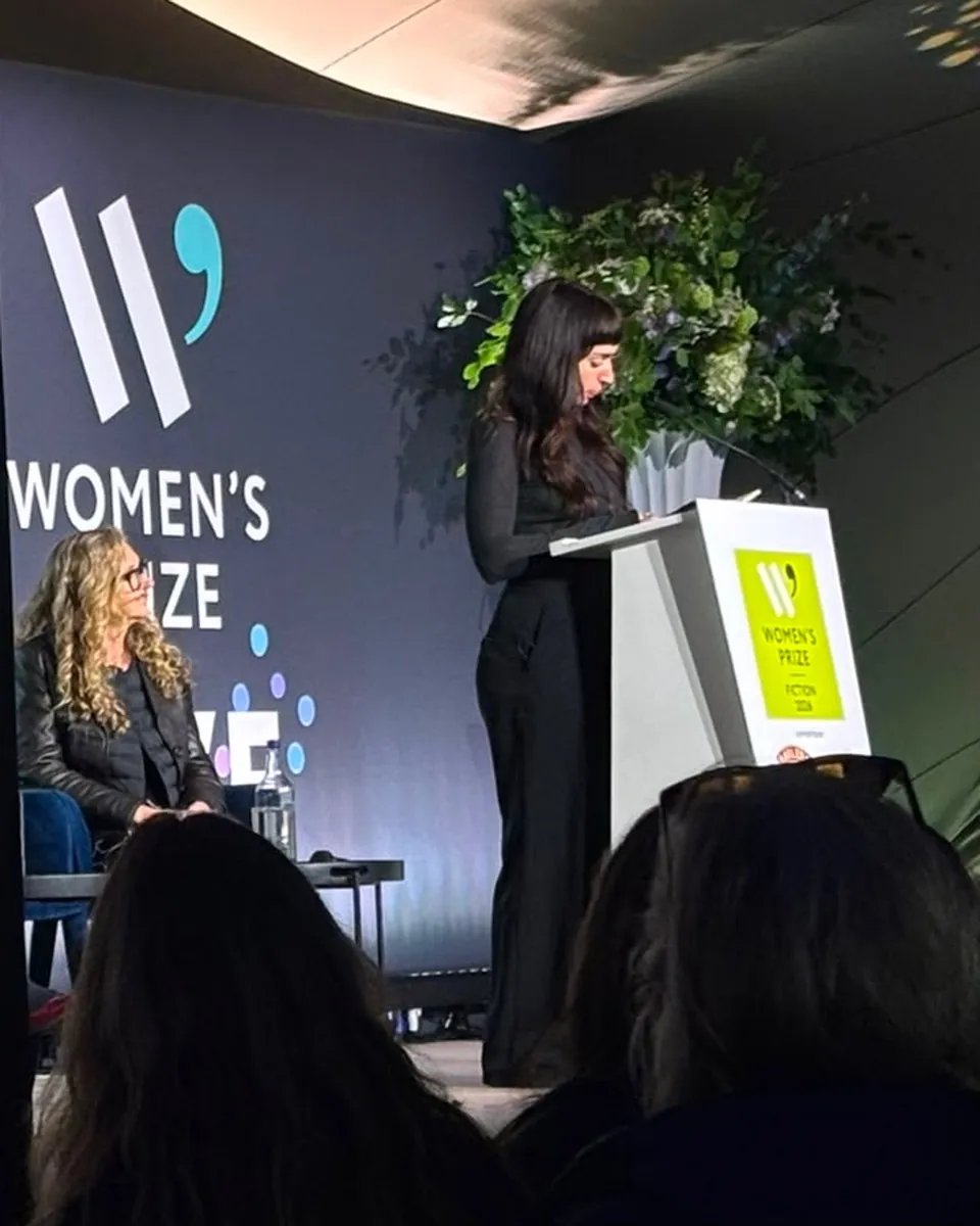 Rozie Kelly reading from Kingfisher on stage at a Women’s Prize for Fiction 2026 event